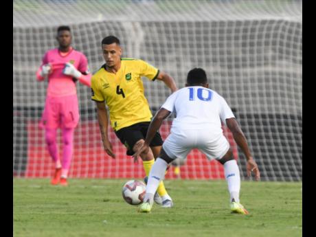 
Jamaica’s Ravel Morrison dribbles towards Panama’s Edgar Barcenas Herrera during the teams’ Concacaf World Cup qualification game at the National Stadium in Kingston, Jamaica, on September 5, 2021.