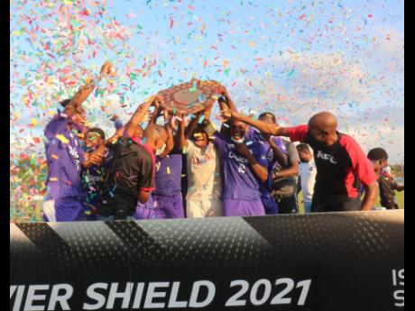 
Kingston College (KC) players celebrate winning the 2021 Olivier Shield at the St Elizabeth Technical High School (STETHS) Sports Complex. KC defeated Garvey Maceo High 2-0. This is KC’s first win since 1986.