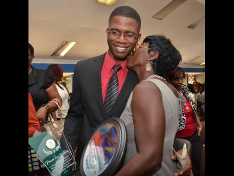 File 
In this file photo, Timar Jackson is warmly embraced by his mother, Janet Powell, during a special assembly at the Vauxhall  High School in Kingston, held in honour  of Timar, who is a past student.  He was recognised for his outstanding scholastic a