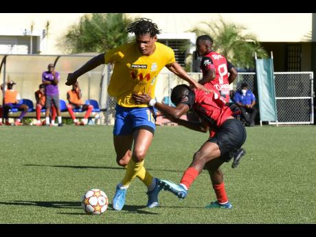 
Harbour View’s Garth Stewart (left) is tackled by Arnett Graden’s Damari Deacon during their Jamaica Premier League encounter at the UWI-JFF Captain Horace Burrell Centre of Excellence yesterday.