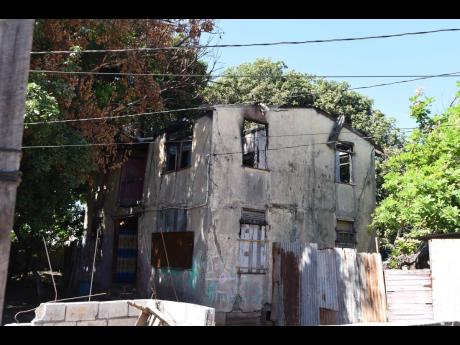 The fire-scarred former home of Bob Marley is inhabited by a family of six that is desperate for relocation.