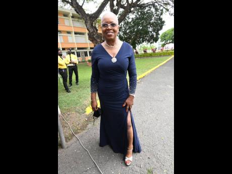 Left: Dr Claudette Morris stepped out in style in a navy dress, styled with a side split.