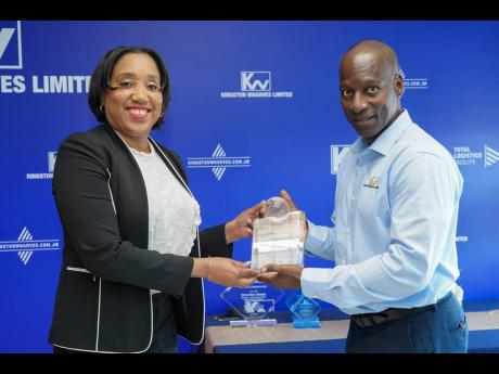 Kingston Wharves CEO Mark Williams presents a Partner Appreciation Award to Commissioner of Customs Velma Ricketts Walker, during International Customs Week recently.