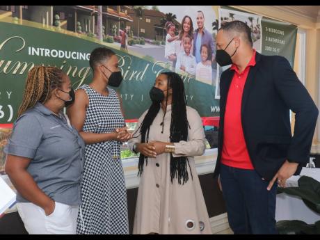 Trelawny North Member of Parliament Tova Hamilton (second right) listens attentively to attorney-at-law Carla Erskine (second left) at the launch of the Greens at the Hummingbird Estate development on Saturday. Sharing in the occasion are JMMB’s Cathay M