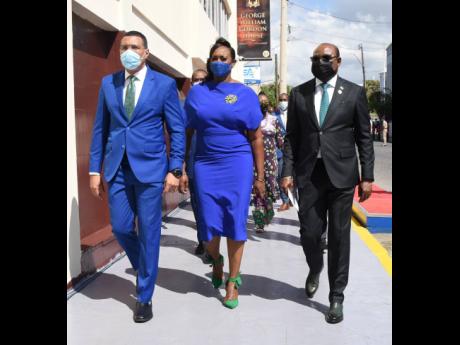 From left: Prime Minister Andrew Holness; wife, Deputy Speaker of the House Juliet Holness; and Edmund Bartlett, minister of tourism, lead the way into Gordon House during the ceremonial opening of Parliament.