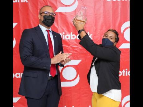 Perrin Gayle (left), head of Retail Banking and Small Business for Scotiabank Caribbean North and Central, congratulates 2021 Scotiabank Vision Achiever participant Cyreca McGaw-Smith, owner and CEO of McGaw and Company. McGaw reported increased sales, pro