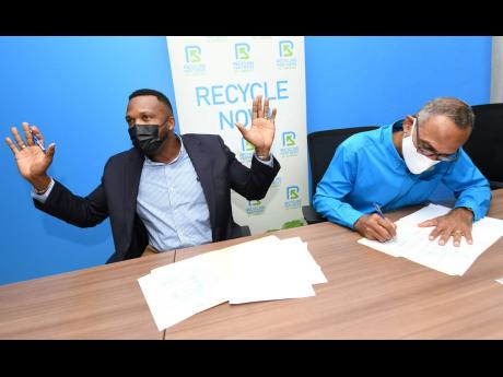 
Jeffrey Campbell, better known as the deejay Agent Sasco, speaks to journalists Tuesday after inking an agreement to remain a brand ambassador for Recycling Partners of Jamaica. To his left is Dr Damien King, chairman of Recycling Partners of Jamaica.