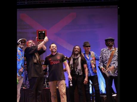 Josh Levy (third left) and members of Third World stand on the A Night of Reggae Music Under the Stars stage following the presentation of the Key to the City of Hollywood. 