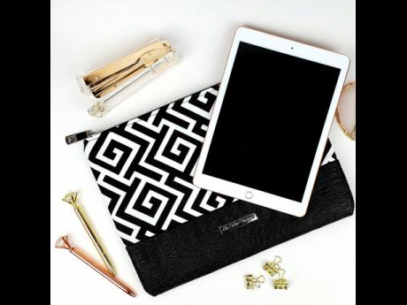 Is this chic black and white purse an oversized clutch or a laptop sleeve? It could actually be both. 