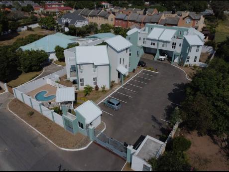 
On March 22, developers and residents head to court to argue over the court-ordered demolition of the more than $100 million town house and apartment complex at 18 Upper Montrose Road in the exclusive Golden Triangle neighbourhood of St Andrew.