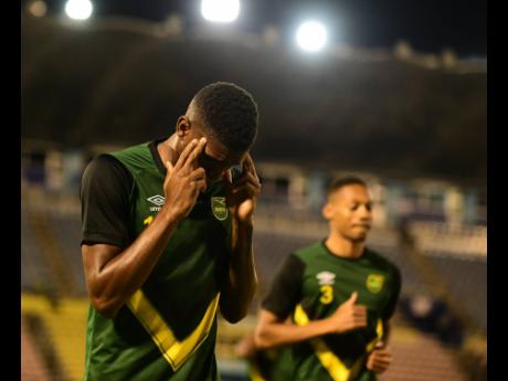 Reggae Boy Damion Lowe warming ahead of a World Cup qualification game against Mexico at the National Stadium in Kingston on January 27.