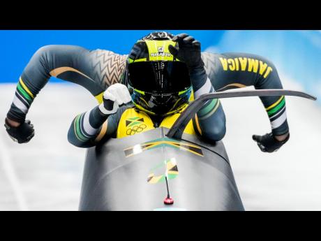 Shanwayne Stephens and Nimroy Turgott, of Jamaica, start the 2-man heat 1 at the 2022 Winter Olympics, yesterday, in the Yanqing district of Beijing. 