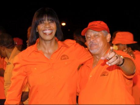 Dr Paul Robertson, former PNP former general secretary, interacts with then Prime Minister and PNP President Portia Simpson Miller during a mass rally in Independence City, Portmore, on July 22, 2007. Robertson died on Saturday.