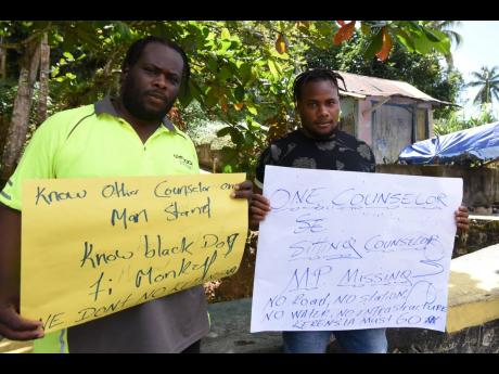 Some of the handful of JLP supporters protesting the imminent sidelining of Troja Councillor William Cytall on Monday. 