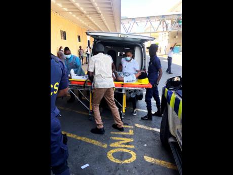 Department of Correctional Services staff seek medical attention for incarcerated entertainer Tommy Lee Sparta at the Kingston Public Hospital in downtown Kingston on Monday.