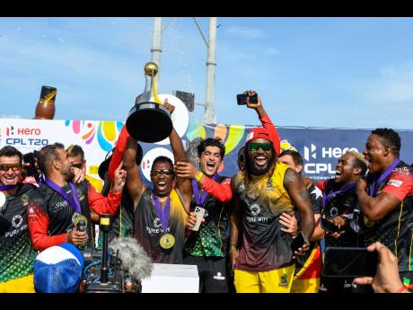 St Kitts and Nevis Patriots captain Dwayne Bravo (centre), Chris Gayle (third right) and their teammates celebrate with the trophy after winning the 2021 Hero Caribbean Premier League final in Basseterre, St Kitts and Nevis.