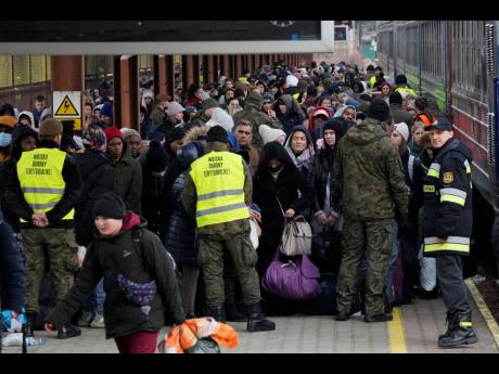 Refugees from Ukraine arrive at the railway station in Przemysl, Poland, on Sunday. As street fighting broke out in Ukraine’s second-largest city, Jamaicans and other refugees sought safety in Poland. 