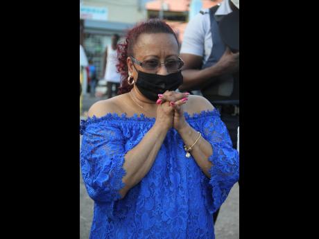 Janett Bhoorasingh-Brown prays for peace during the Clarendon Neighbourhood Watch Peace March on Tuesday.