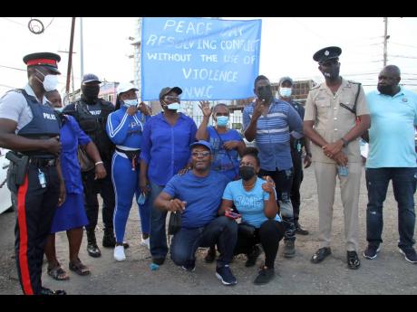Deputy Superintendent of Police Owen Brown (second right), who heads the Community and Safety Branch, with members of the Clarendon Neighbourhood Watch Council during Peace Day activities in the May Pen town centre.