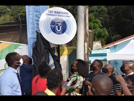 East Rural St Andrew Member of Parliament Juliet Holness and officials of the Universal Service Fund unveil a new Wi-Fi tower in the community of Top Maryland under the watchful eyes of the eager residents.