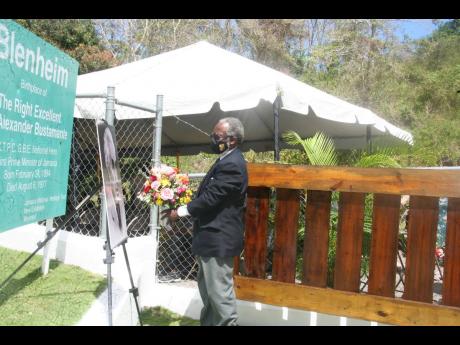 Custos of Hanover Dr David Stair prepares to lay a floral tribute in commemoration of the 138th anniversary of the birth of Jamaica’s first prime minister and national hero, Sir Alexander Bustamante, at his birthplace in Blenheim, Hanover, last Thursday.