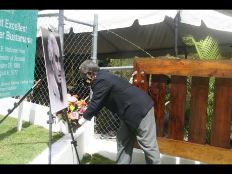 Custos of Hanover Dr David Stair prepares to lay a floral tribute in commemoration of the 138th anniversary of the birth of Jamaica’s first prime minister and national hero, Sir Alexander Bustamante, at his birthplace in Blenheim, Hanover, last Thursday.
