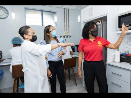 From left: Dr Marsha Chong, consultant, Department of Anaesthesia and Intensive Care; Gail Patterson, principal, Lynshue Design and Build, member of Virgin International, contractors; and Heather Goldson, Supreme Ventures Foundation (SVF) director, examine