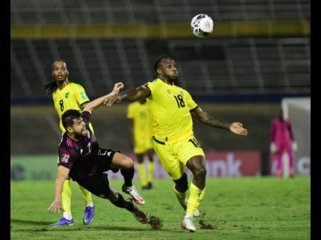 
Jamaica’s Michail Antonio (right) battles Mexico’s Nestor Araujo for the ball in a World Cup qualifier at the National Stadium in St Andrew in January.
