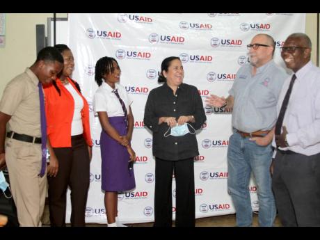 Paul Teeple (second right), chief of party for the United States Agency for International Development (USAID) Positive Pathway’s activities in Jamaica, in discussion with, from left: Christopher Rowe, student; Sandra Knight-Edwards, vice principal, Foga 