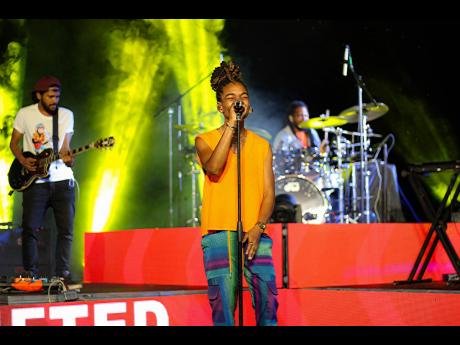 As the stage gets heated, the young, reggae-dancehall sensation gets comfortable by removing her jacket.