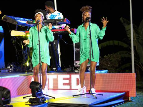 Background vocalists Natascia Bryan (left) and Ovasha Bartley became one with the lyrics and rhythm as they supported Koffee on stage.