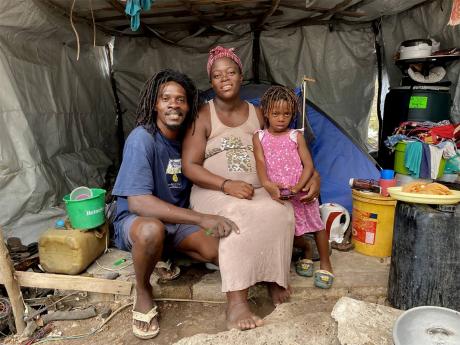 Parnel Peart, his wife, Anakay Thomas Peart, and daughter Zemora inside the tent where they sleep at nights along Bob Marley Beach in St Thomas.