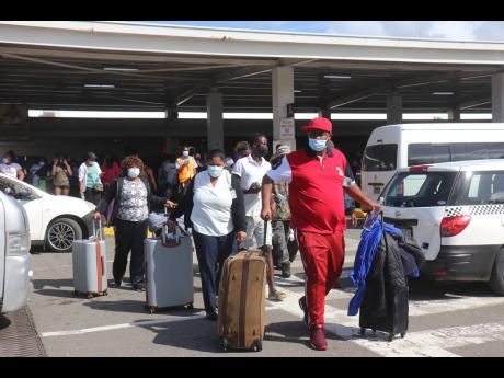 Tourists arrive at Sangster International Airport in Montego Bay St James on Wednesday, December 15, 2021. The airport is seeking to ease processing wait times on weekends.