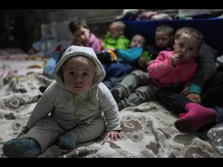 Children gather in a bomb shelter in Mariupol, Ukraine, on Sunday. Two million people have fled the Eastern European country since it was invaded by Russian forces two weeks ago. 