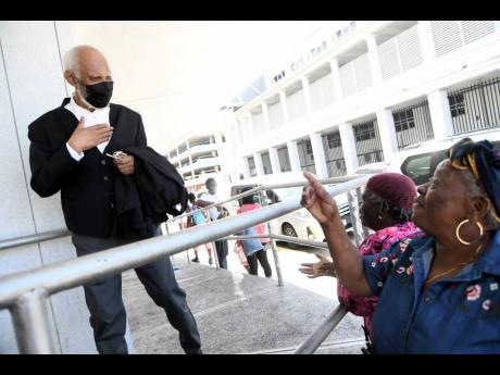 Attorney-at-law K.D. Knight greets onlookers before entering the Supreme Court building for the Trafigura hearing on Tuesday. Knight represents the five functionaries aligned with the People’s National Party that formed the Government in 2006.