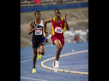 Yoshane Bowen (right) of Maggotty High wins the Under 17 boys 1500m in 4:09.21 ahead of Tyrone Lawson of Jamaica College on Friday's opening day of the 2022 Carifta Trials.