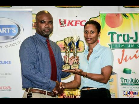 Leroy Spence receiving one of his many trophies after a Rally Jamaica event.