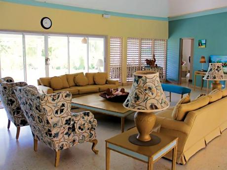 The living room opens out to the pool and golf course.