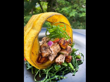 The juicy jerk chicken, ripe plantain bites surrounded by a crisp green plantain ring, is bliss on a plate.