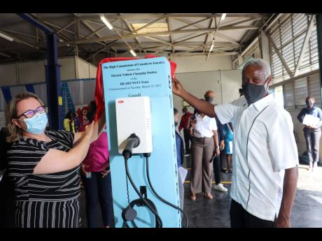 Canadian High Commissioner to Jamaica Emina Tudakovic and HEART/NSTA Trust Board Chairman Professor Alvin Wint unveil a plaque recognising the donation of an electric vehicle charging station to the HEART/NSTA Trust. The official handover was held on Tuesd