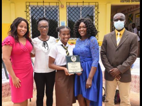 Black River High School student Yhannai Ferron (third left) shows off her latest award as she poses with (from left) Withney Smith-Currie, councillor, Brompton Division; mom Caraleene Stevens; Sonya Moulton, founder, Children of Light; and Principal Christ
