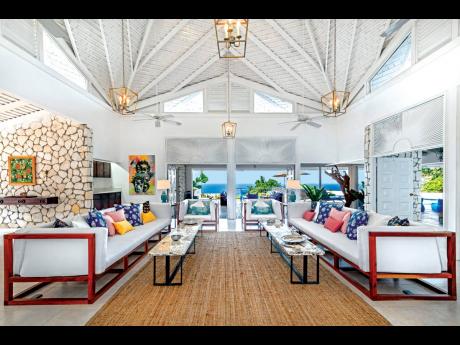The living room with its unusual ceiling overlooks the golf course and sea.