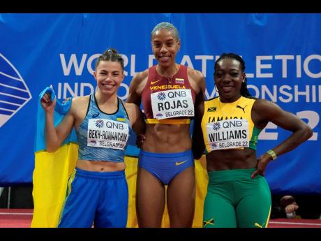 Jamaica's bronze medallist Kimberly Williams (right) poses with  gold medal winner Yulimar Rojas (centre) of Venezuela and silver medalist Maryna Bekh-Romanchuk, of Ukraine after the women's triple jump final at the World Athletics Indoor Championships in 