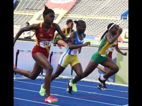 Wolmer's High School for Girls' Tiana Marshall (left) drives to the finish line to win the class four girls' 70-metre hudles ahead of (from left) Hydel High School's Tihanna Reid, Vere Technical's Kecia King, and Marshall's teammate, Natrilia Campbell at l