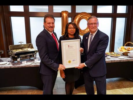 Senator Joseph Addabbo (left) presents Resorts World Casino New York City a proclamation honouring its 10th anniversary. Receiving the proclamation are Michelle Stoddart and Robert DeSalvio, president of Genting America’s East.