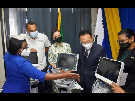 Beverley Senior Berry (left), director of nursing services, explains the importance of the equipment to (from second left) Dr Christopher Tufton, minister of health and wellness; Kamina Johnson Smith, minister of foreign affairs; Lim Beajin, chargé d’af