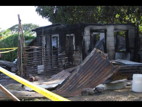 The burnt-out shell of the Haylesfield, Clarendon, home in which two infant girls were burnt to death yesterday.
