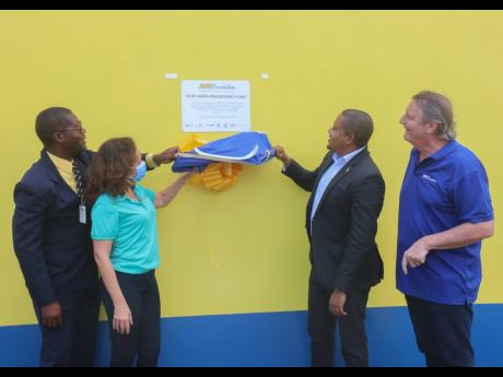 Minister without portfolio in the Office of Prime Minister, Floyd Green (second right), participates in the unveiling of the Elim agro-processing plant with, from left:  Milbert Miller, principal, Sydney Pagon Stem Academy; Laetitia Chevillard, senior supp