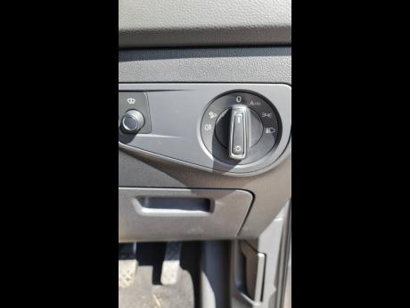 The headlights are controlled by a knob beside the steering. 