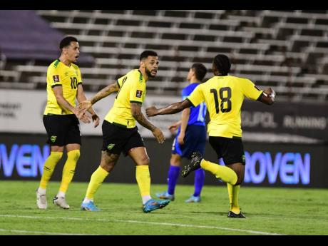 
Jamaica’s Andre Gray (second left) celebrates the goal he scored with teammates Ravel Morrison (left) and Atapharoy Bygrave during a Concacaf World Cup qualifier at the National Stadium on Thursday. 